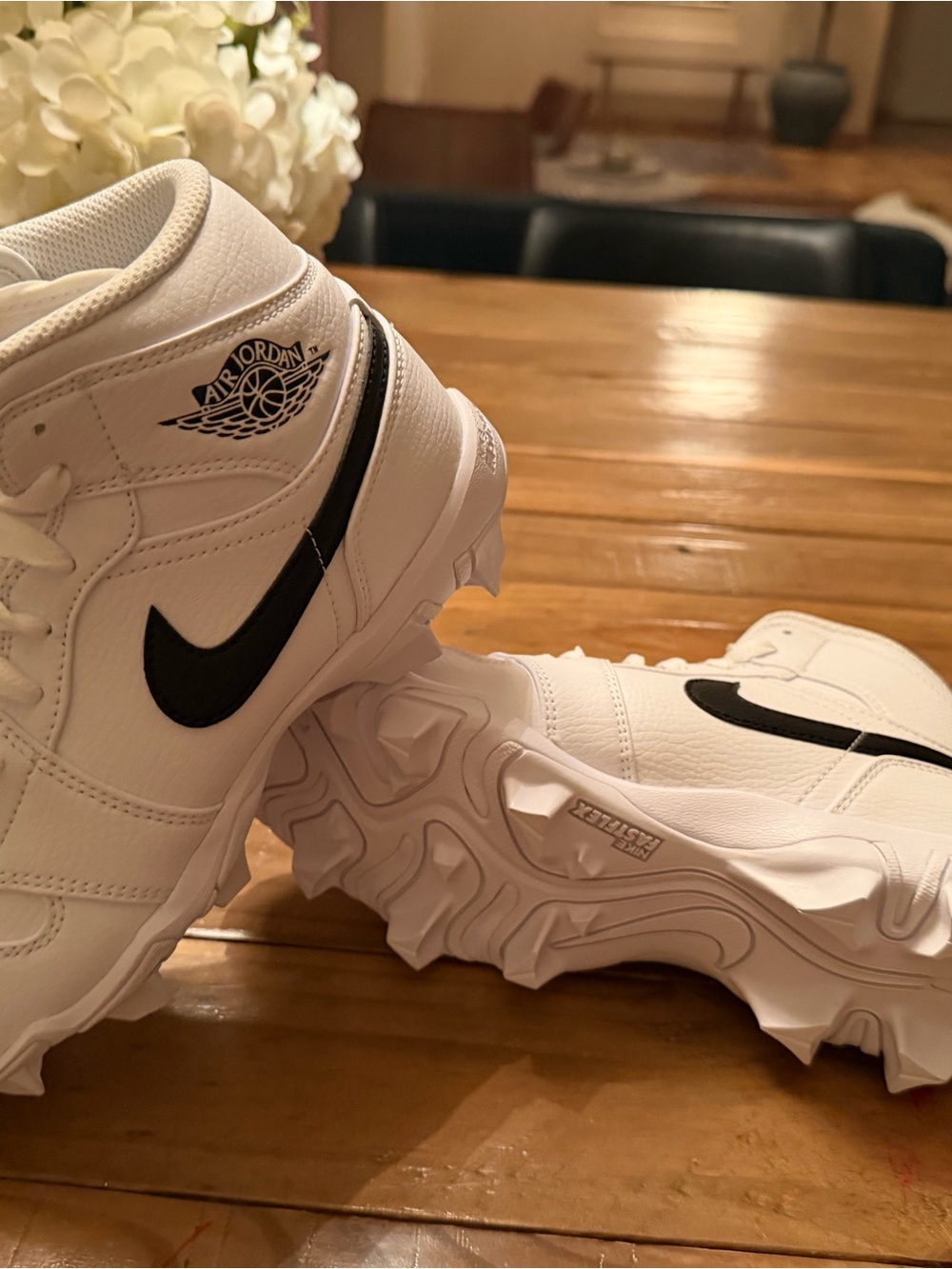 Air Jordan White hightop cleats with black Swoosh